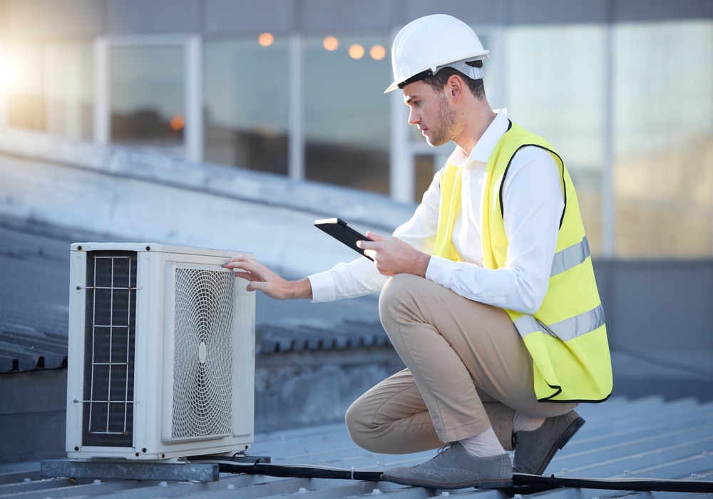 HVAC technician repairing an AC not cooling properly in a residential home