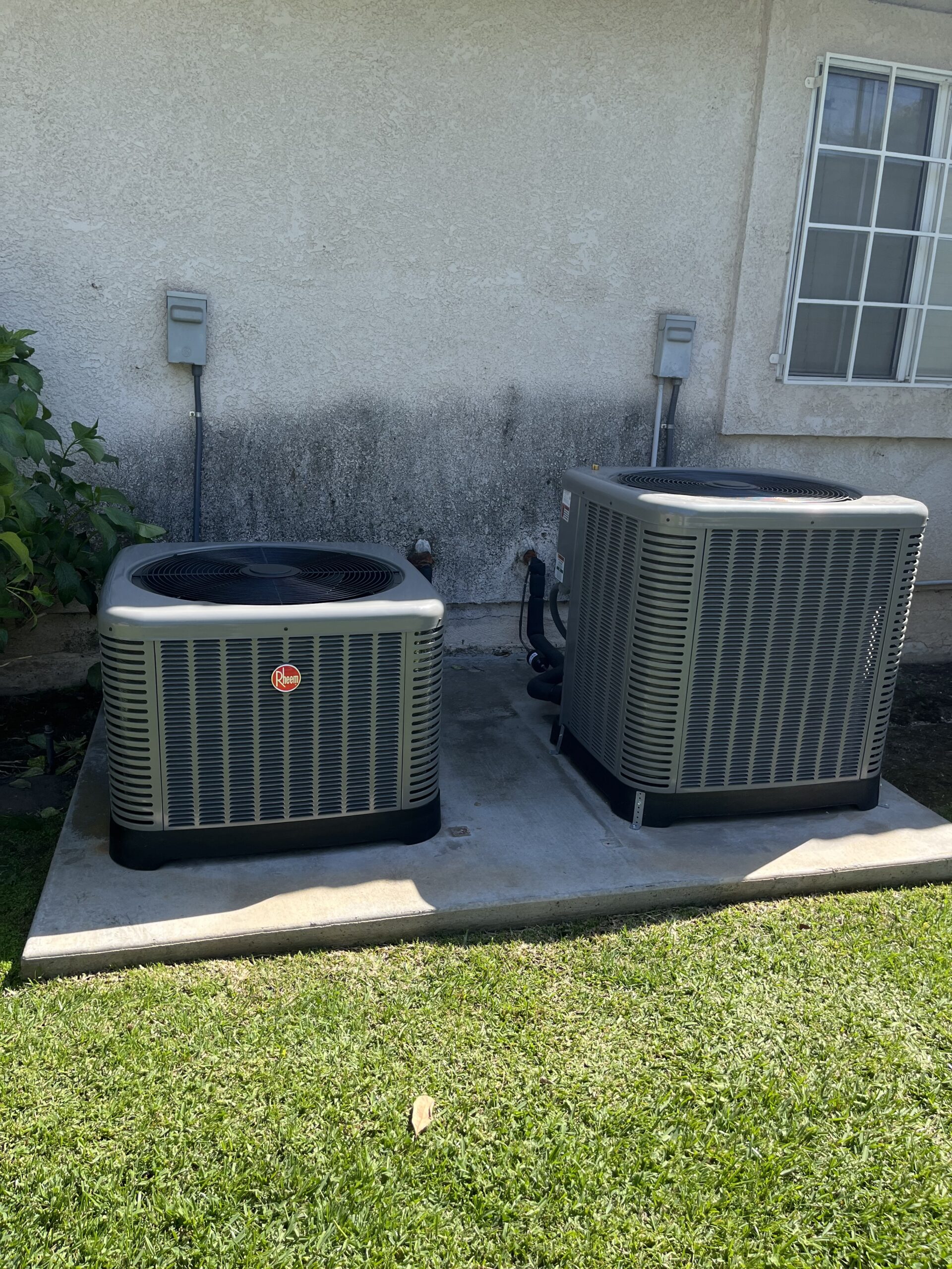 Homeowner checking thermostat while HVAC technician inspects an AC system running but not cooling in a residential home.